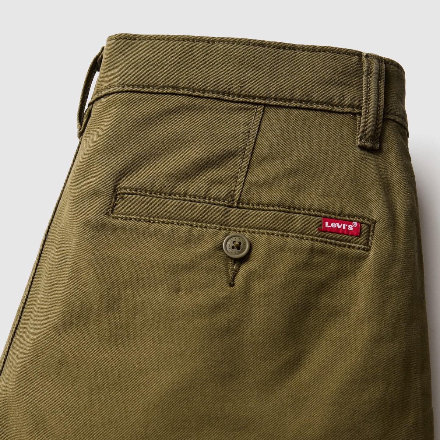 Close-up of olive Levi's shorts with back pocket