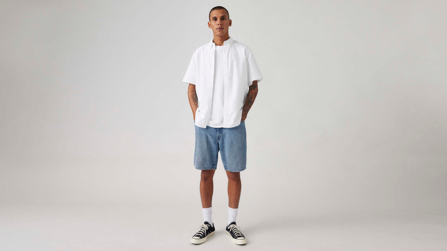 Man in Levi's light-blue denim shorts and white shirt