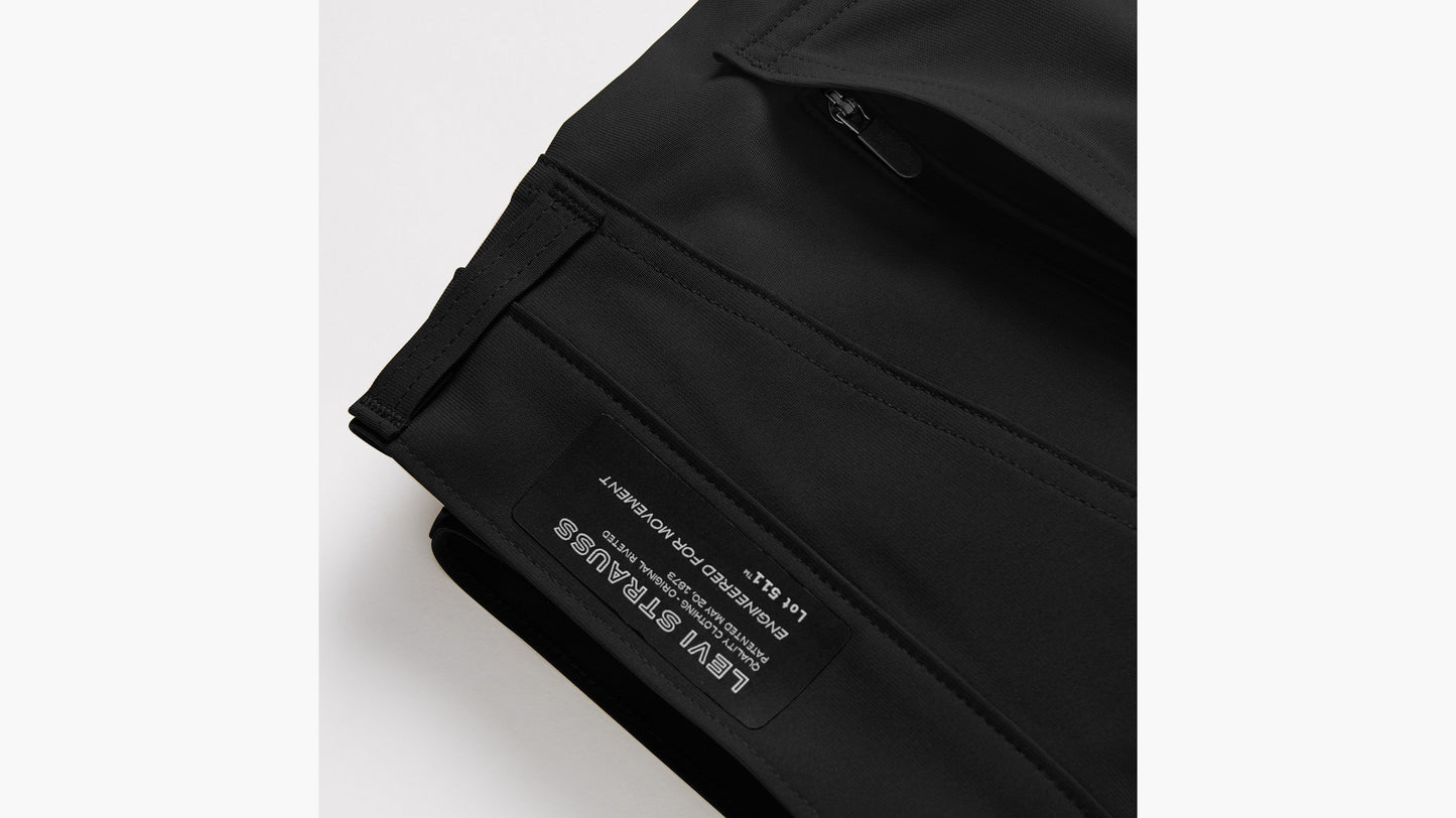 Detail of Levi’s black tech pant hem with zip pocket and branding