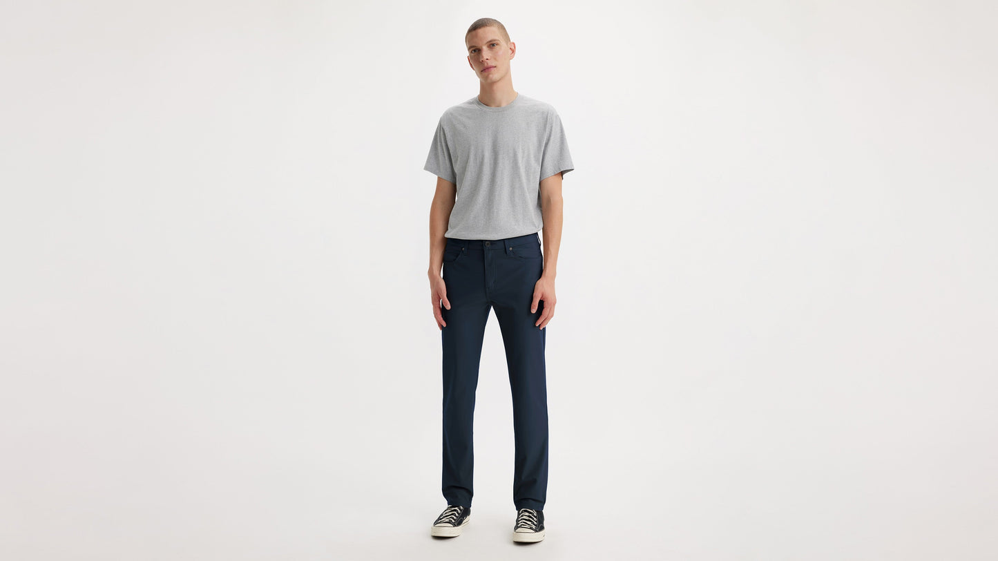 Model in Levi’s navy slim tech pants and grey tee, front view