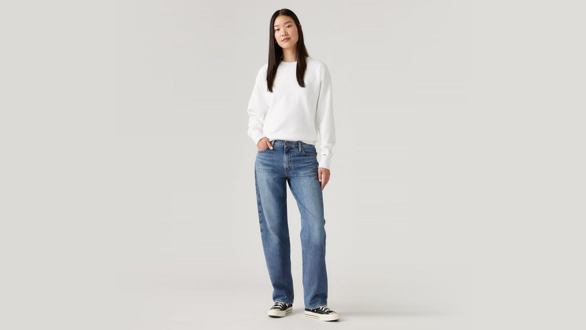 Woman in Levi's 94 Baggy jeans and white sweatshirt, front view