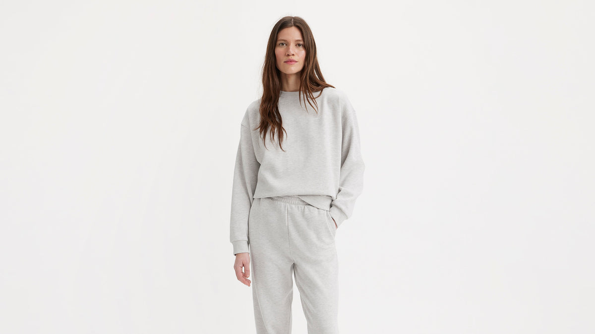 Woman in light grey Levi's sweatshirt & matching joggers