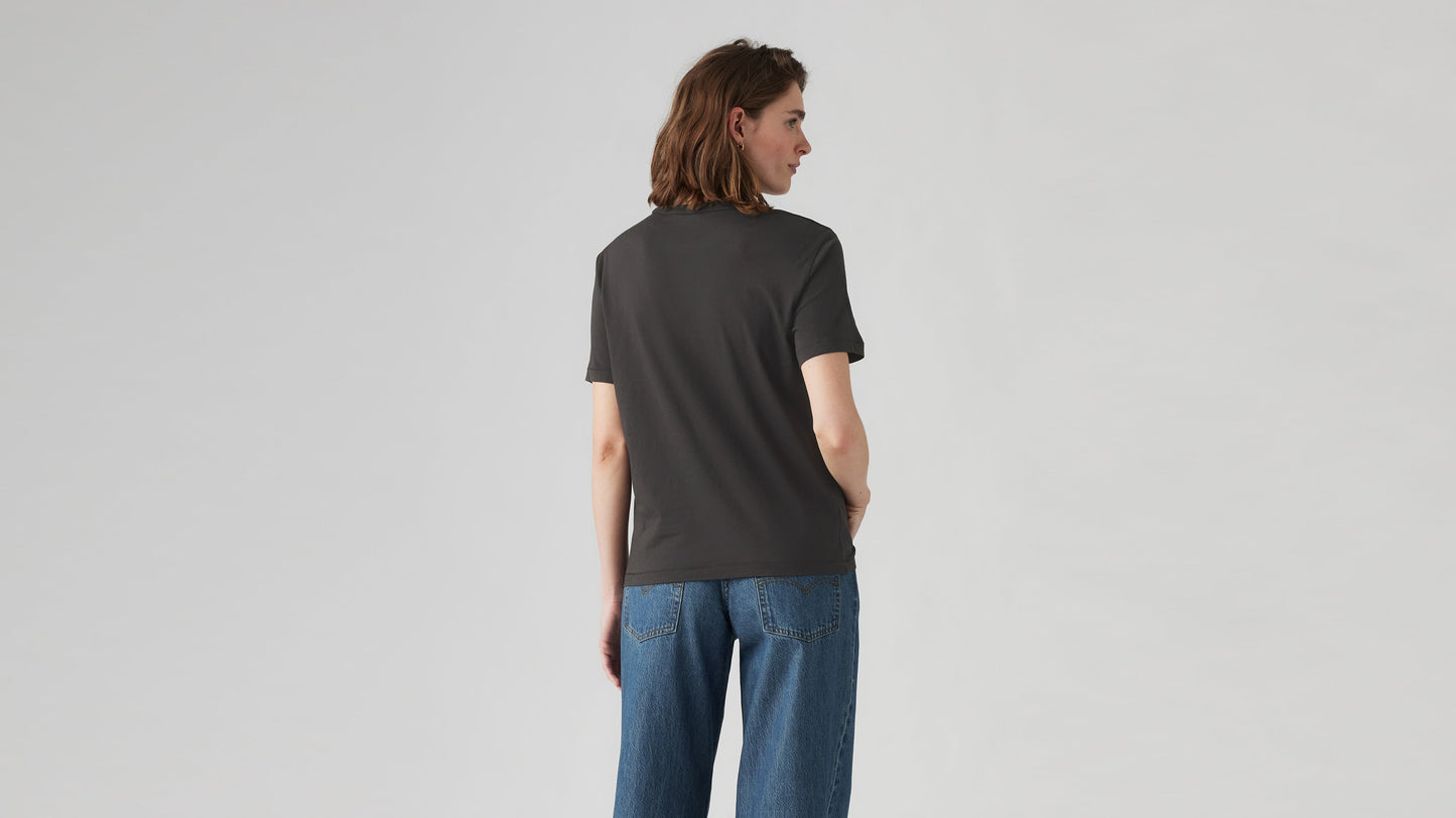 Back view of woman in dark Levi’s iconic tee and classic blue high-waisted jeans