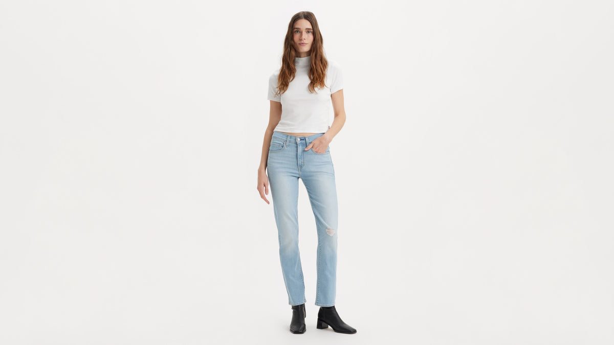 Woman in light-wash Levi's jeans and turtle-neck tee