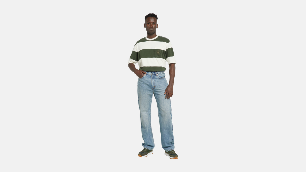 Man in Levi's light-blue jeans and green striped tee