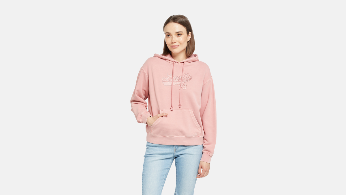 Woman in Levi's logo sweatshirt in pastel pink