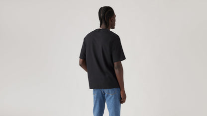 Back view of man in black Levi's Batwing Graphic Tee with jeans