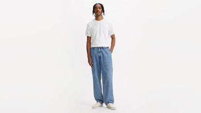 Front view of man in chino loose straight pants and plain tee, hands by his sides