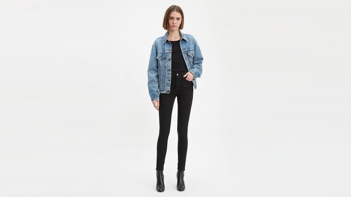 Levi's 310 Shaping Super Skinny Jeans on woman, front view with denim jacket