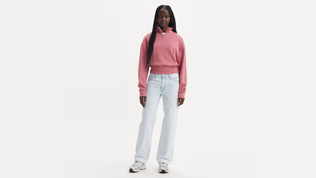 Model in pink pullover and light-wash Levi's '94 Baggy Jeans