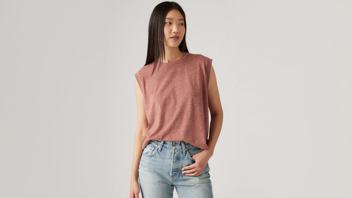 Woman wearing red boxy tank top and jeans
