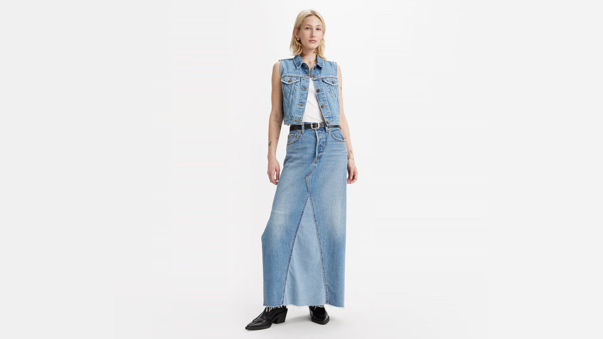 Front view of a Woman in Levi's blue denim icon long skirt, white tank & vest outfit