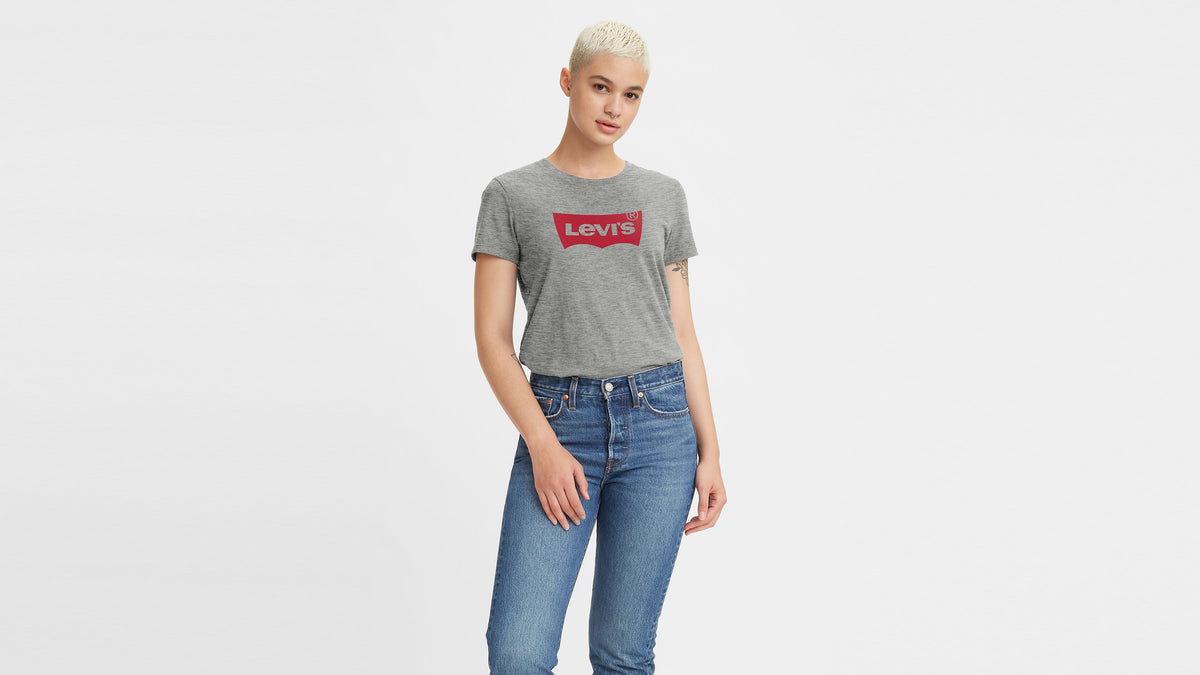 Woman wears grey Levi’s perfect tee and high-rise jeans, front-facing pose