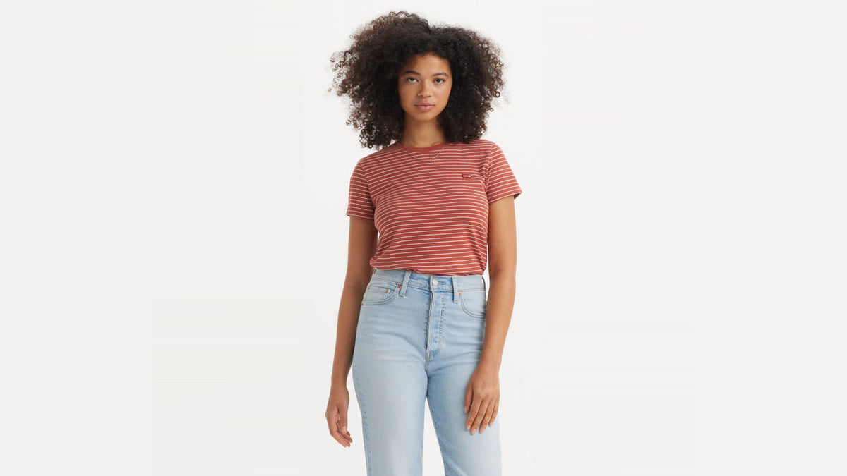 Front view of woman in red striped Levi's tee & light-wash high-rise jeans