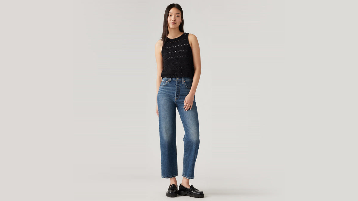 Model in Levi's straight jeans styled with crochet black top & loafers